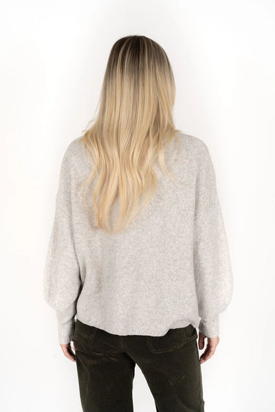 woman facing the back wearing Chantae Jumper - Snow and black pants
