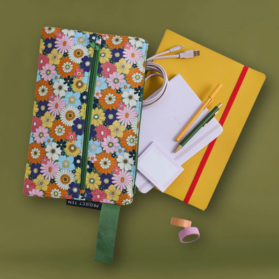 Floral notebook with Posy Pencil Case, stationery items on a green background