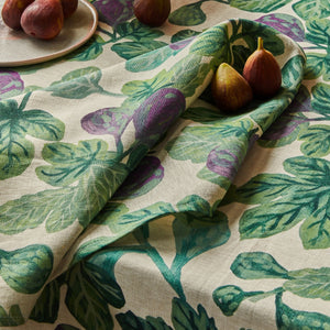 Figs resting on a fig-patterned anpkin set with a folded corner.