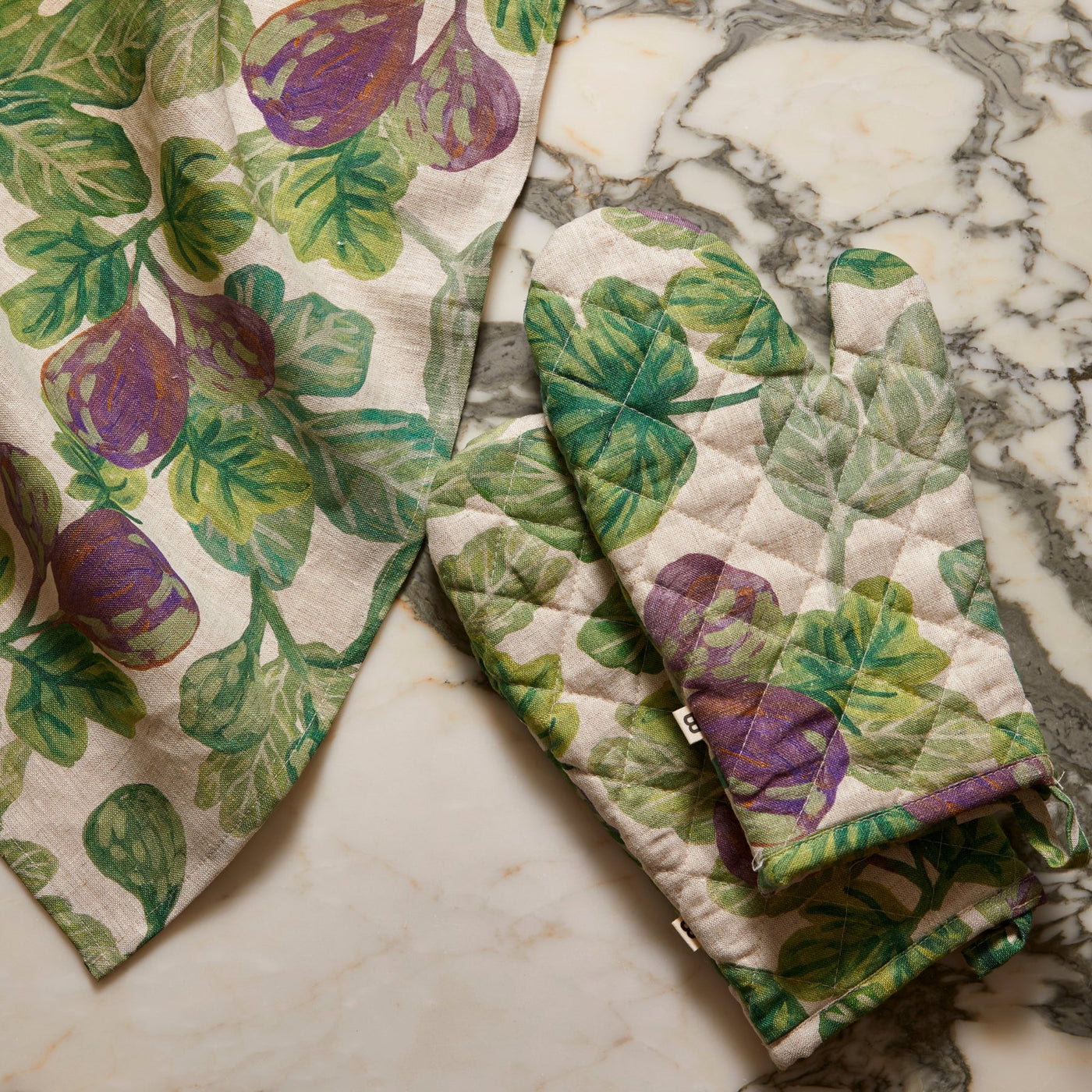figgy green quilted linen mitt and figgy green tea towel in the counter top