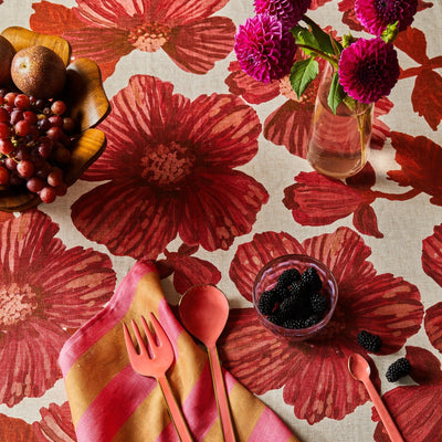 Table set with leon cerise round tablecloth, striped pink and gold napkins