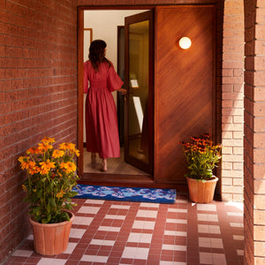 woman in the house entrance with Pansy Blue Long Door Mat