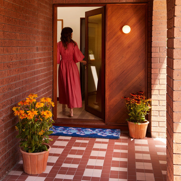woman in the house entrance with Pansy Blue Long Door Mat
