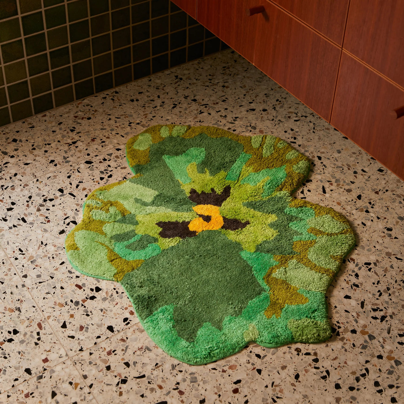 tiled bathroom with Pansy Green Bath Mat beside cabinet