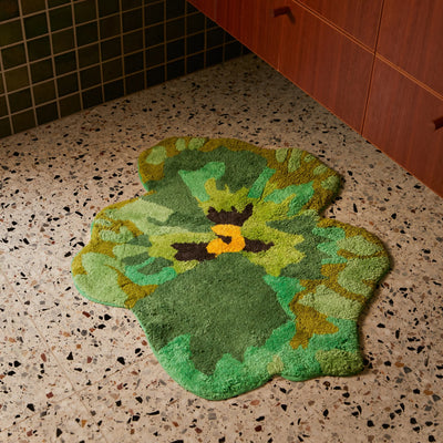 tiled bathroom with Pansy Green Bath Mat beside cabinet