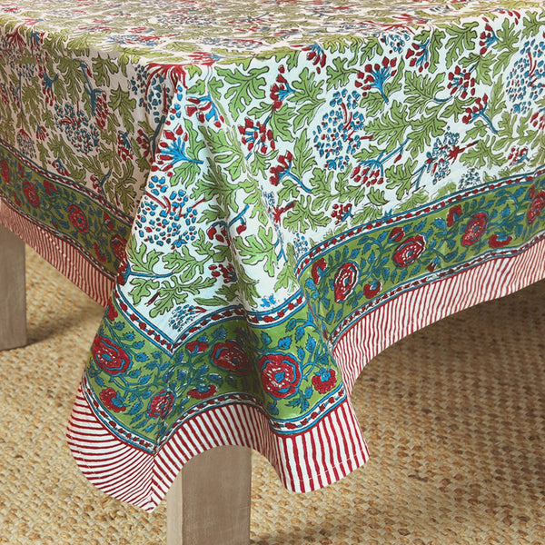 table with canvas and sasson tableau joy tablecloth features a continuous floral design in scarlet red, sky blue and fern on a white base, finished with a scarlet red and white striped border
