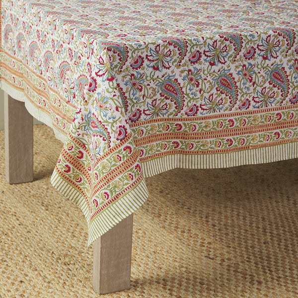 table with canvas and sasson tableau tablecloth in Paisley patterns, intricately formed and surrounded by florals in an eye-catching summer-inspired palette.