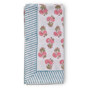folded canvas and sasson tableau napkin in all-over poppy print in hues of pinks and greens s on a white cotton base, finished with a beautiful blue and white striped border.