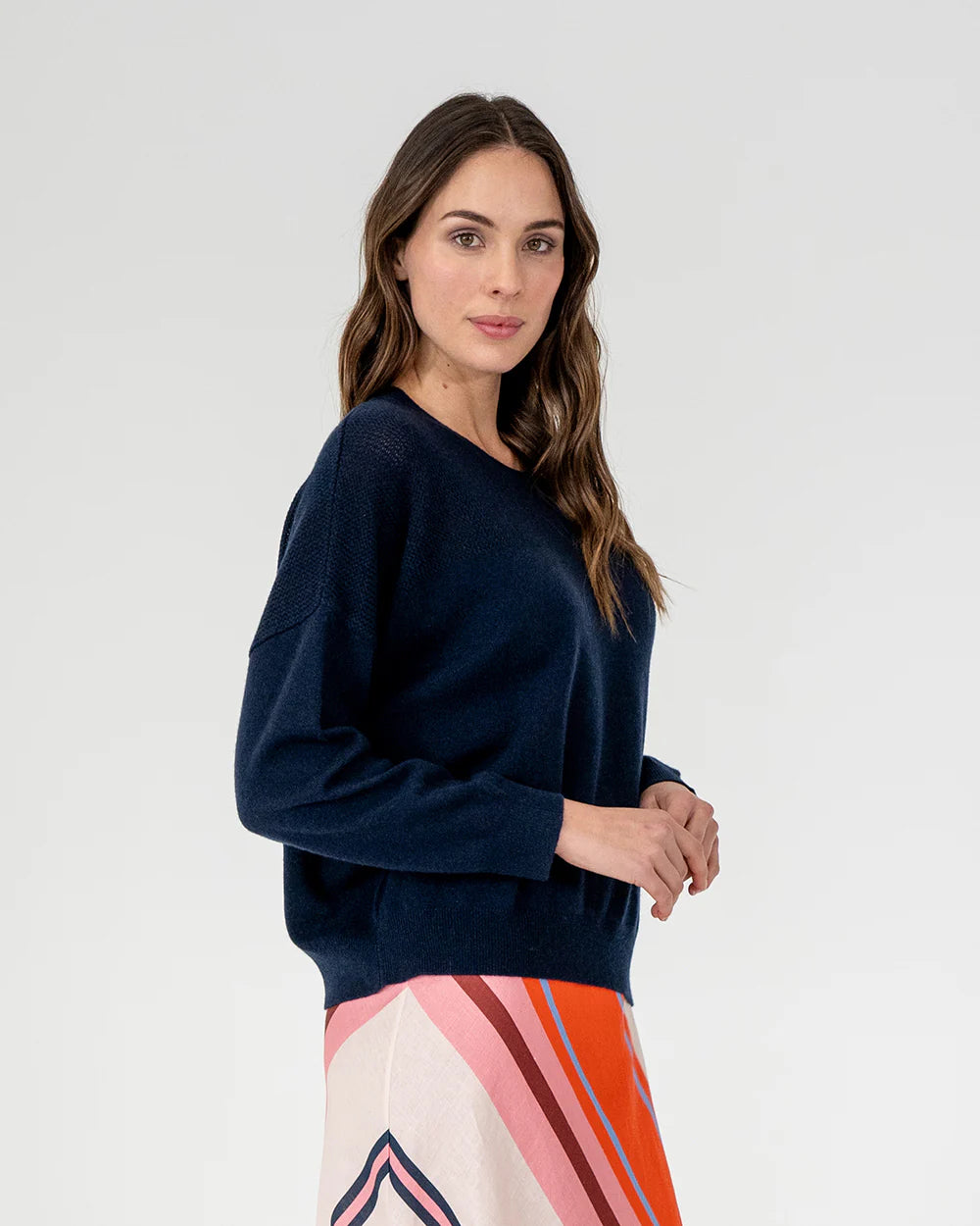 woman wearing Mornington Knit - Navy and skirt with diagonal stripe design