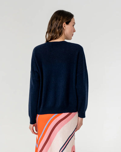 woman facing the back wearing Mornington Knit - Navy and skirt with diagonal stripe design