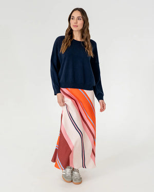 woman wearing Mornington Knit - Navy and skirt with diagonal stripe design