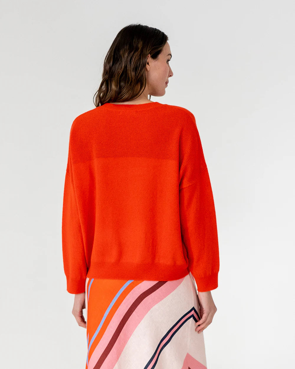 woman facing the back wearing Mornington Knit - Poppy and skirt with diagonal design
