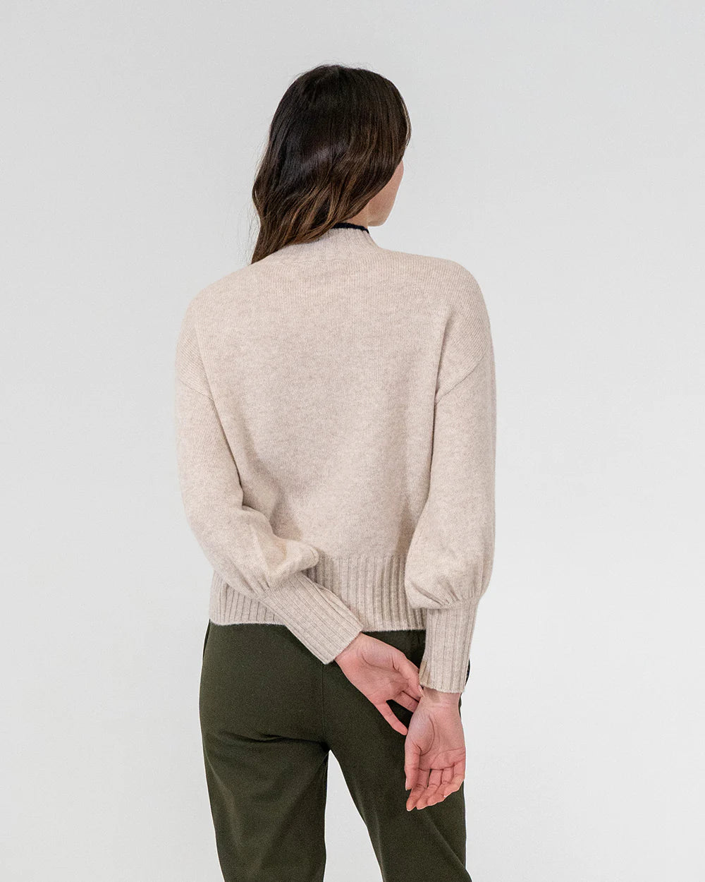 woman facing the back wearing Steward Knit - Oatmeal and khaki bottoms