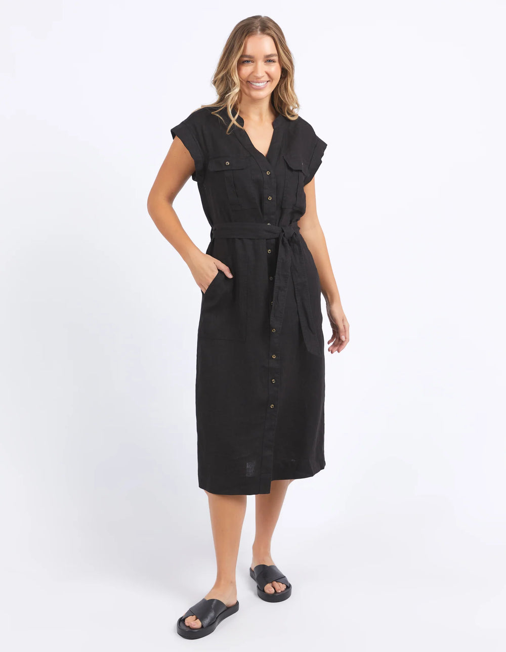 woman wearing foxwood harlow dress in black with her hand in the dress pocket