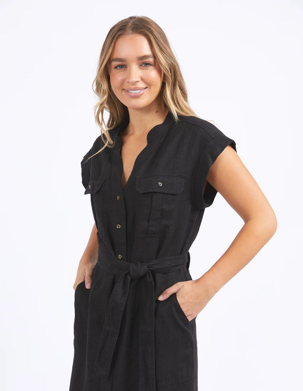 woman wearing foxwood harlow dress in black with her hand in the dress pocket