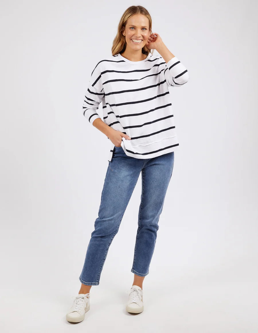 woman wearing denim pants and foxwood jayne stripe throw on top white dark  sapphire stripe