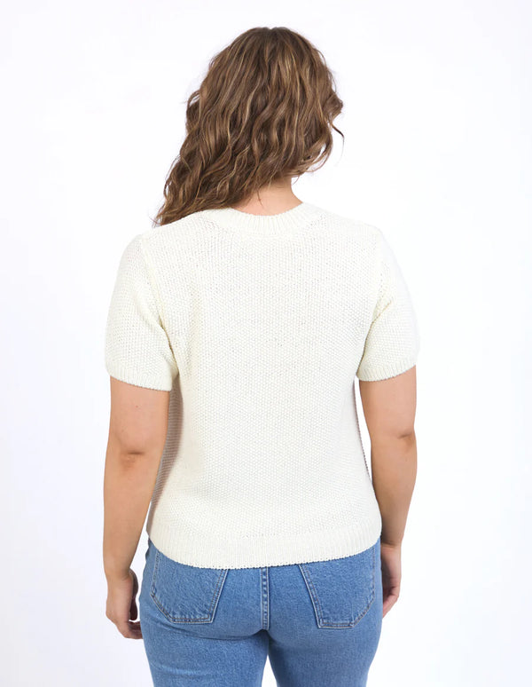 Back details of Blair Short Sleeve Knit Vintage White and denim pants