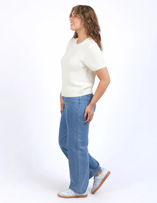 Woman wearing Blair Short Sleeve Knit Vintage White and denim pants