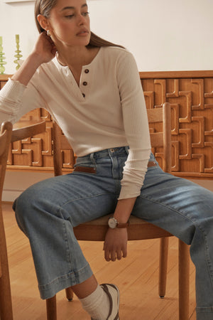 Campaign close-up of Freya Jean Leather Pocket 70s Blue showing PU leather pocket detail, model seated