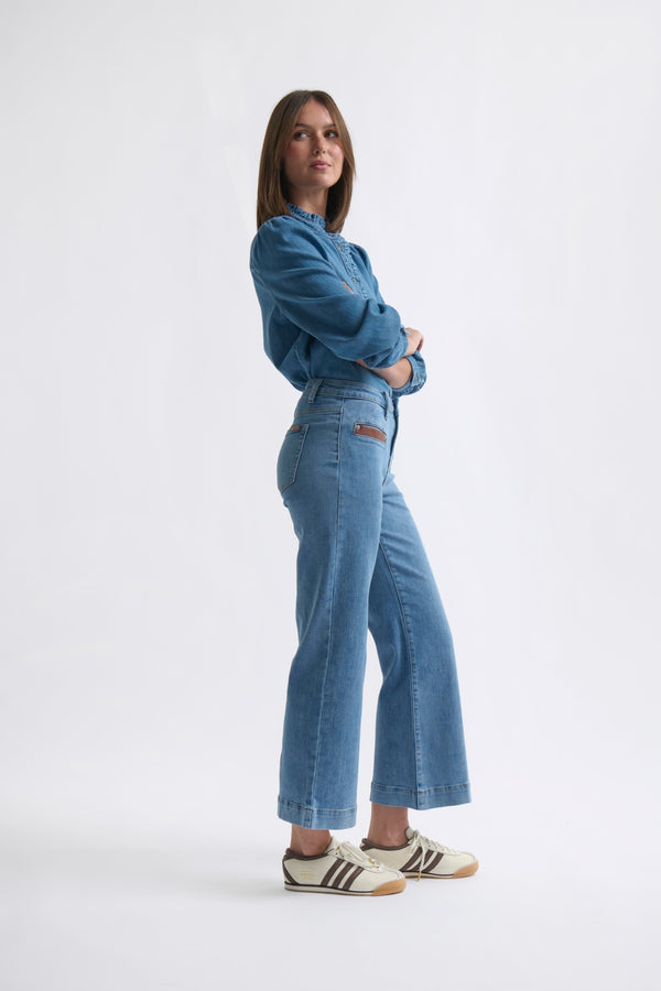 Side profile ecom shot of Freya Jean Leather Pocket 70s Blue showing wide flared leg and leather welt pocket detail
