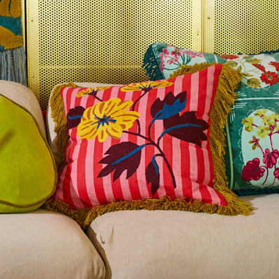 sofa with cushion in forest  and Annette Embroidered Cushion - Cosmo Pink