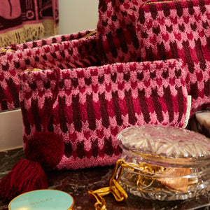 Different size Arlette Terry Pouch - Cosmo Pink placed in vanity cabinet