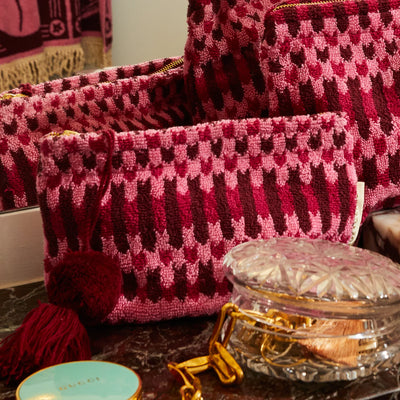 Different size Arlette Terry Pouch - Cosmo Pink placed in vanity cabinet