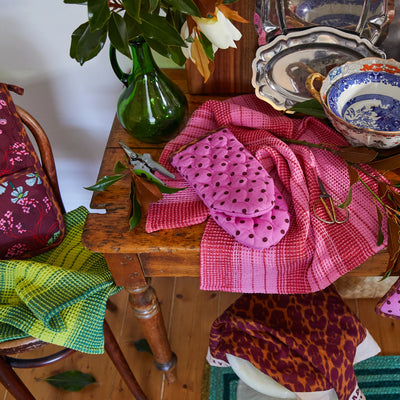 table Brigitte Tea Towel - Cosmo Pink, mitt, flower vase with flower top view