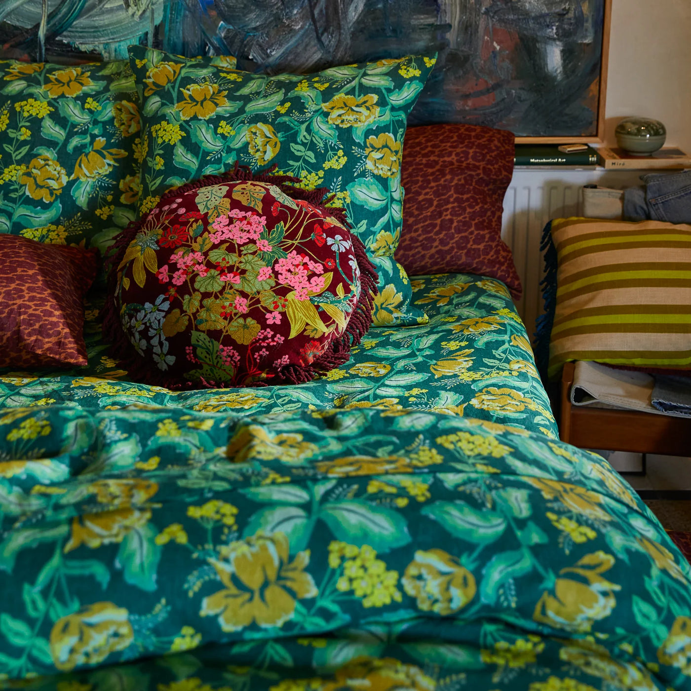 bed with green floral pillowcase, odete linen pillowcase, green floral bed cover, and Genevieve Fringe Cushion
