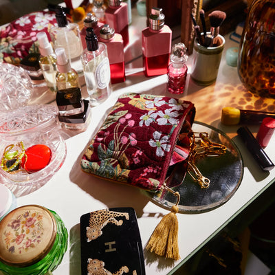 vanity table with make and fragrance and Genevieve Velvet Pouch