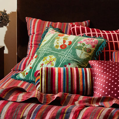 bed with stripe bed cover and pillow with Gigi Velvet Cushion - Forest