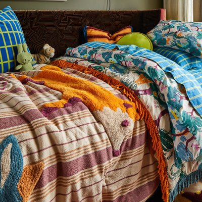 bed with blue green print pillow case and Jarvis Tufted Bedcover