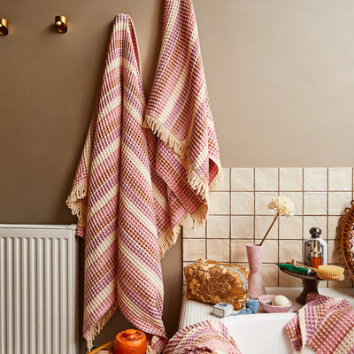 sage and clare kanti waffle towel in posy placed in bathroom hook