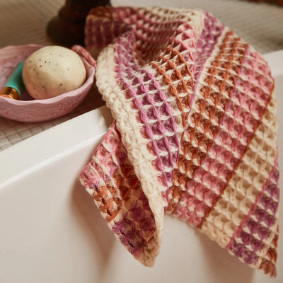 sage and clare kanti waffle towel in ponsy place beside a bowl with circular soap
