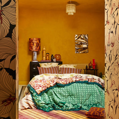 Bedroom with yellow and brown stripe pillowcase and Mallorie Velvet Blanket