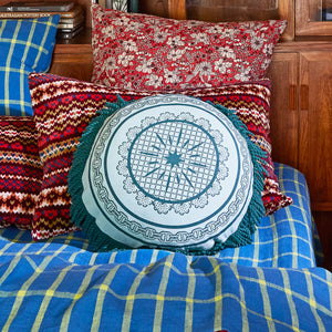 Bed with printed pillow and blue bed cover and Manville Fringe Cushion