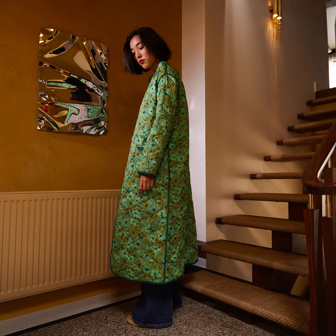 woman wearing Margot Quilted Coat near staircase