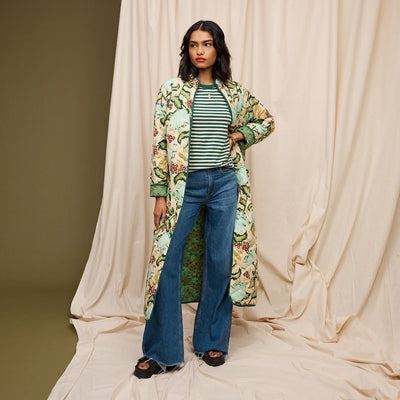 woman wearing green and white stripe and dark denim pants with Margot Quilted Coat