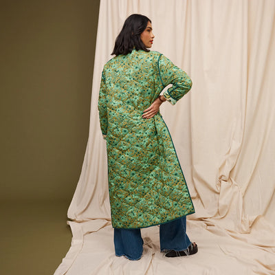 Woman wearing Margot Quilted Coat and dark denim pants facing the back