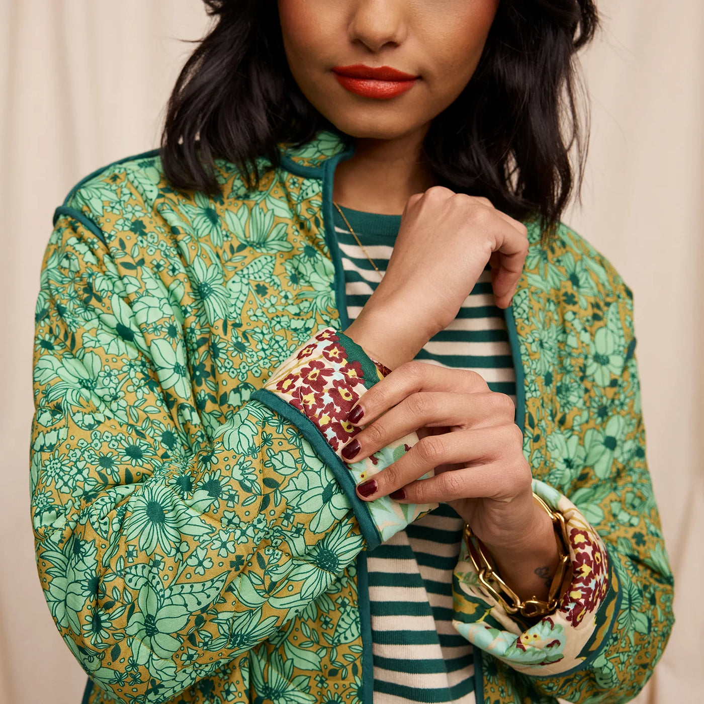 closer look of woman wearing green and white stripe top and Margot Quilted Coat sleeve details