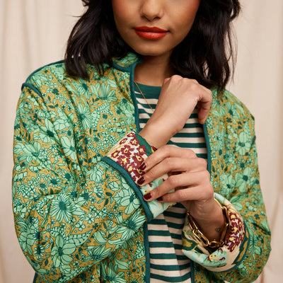 closer look of woman wearing green and white stripe top and Margot Quilted Coat sleeve details
