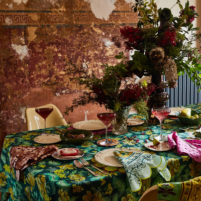 table with Margot Table Cloth in Forest with flower arrangement and plates