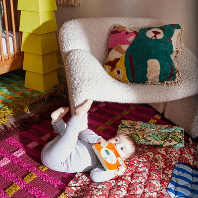 baby beside chair with Monty Tufted Cushion