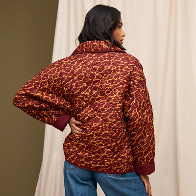 Woman facing the back wearing denim pants and Odette Quilted Jacket