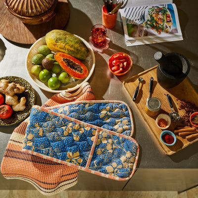 sage and clare salina double oven mitt, fresh fruit, and spices on a kitchen counter.
