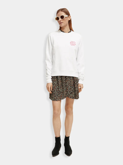 woman wearing Elasticated Waist Mini Dress - Creatures Print with white shirt