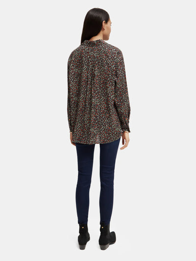 woman wearingOversized Print Shirt - Creatures Print and denim jeans back view