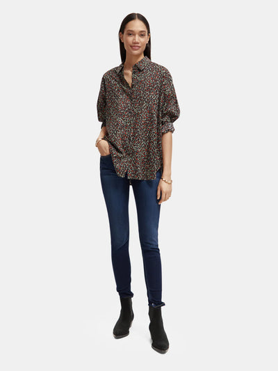 woman wearingOversized Print Shirt - Creatures Print and denim jeans front view