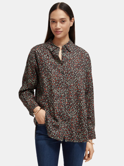 woman wearingOversized Print Shirt - Creatures Print and denim jeans