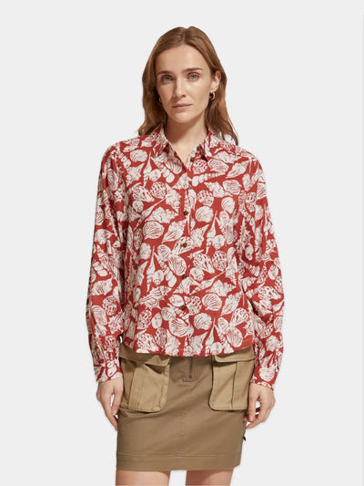 man wearing Printed Balloon Sleeve Shirt - Shell Batik and brown mini skirt